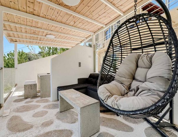 Hanging chair on the covered terrace of Mountain Bliss Guesthouse 2