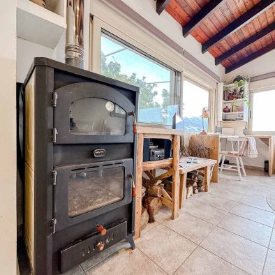 Wood stove in the living room of Mountain Bliss Guesthouse 1