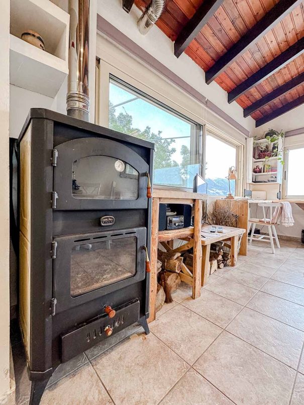 Wood stove in the living room of Mountain Bliss Guesthouse 1