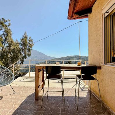 Outdoor workspace with panoramic mountain views at Guesthouse 1