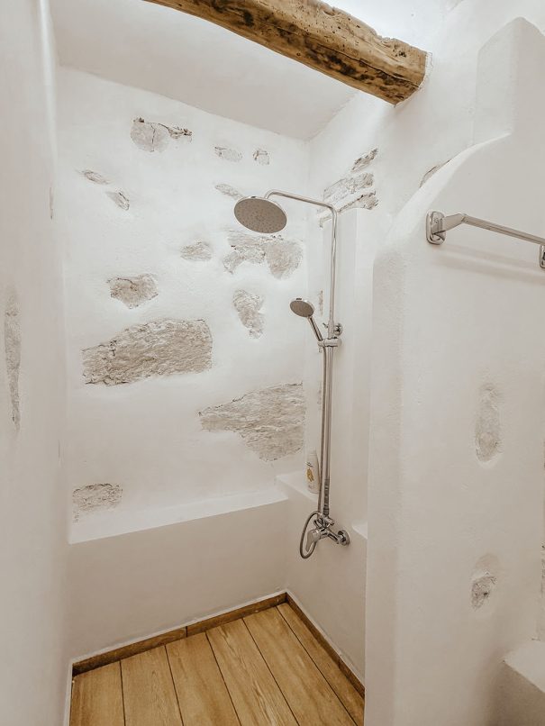 Walk in shower with natural stone details in Guesthouse 3